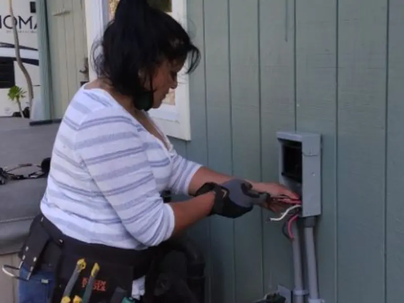 Licensed electrician wiring an exterior subpanel in Dorr